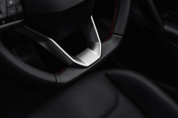 istock Bottom part of car steering wheel with silver elements. 2205932930