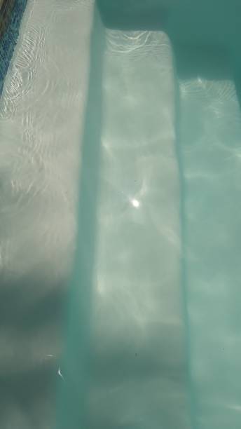 istock pool stairs with the glare of the sun 2205935849
