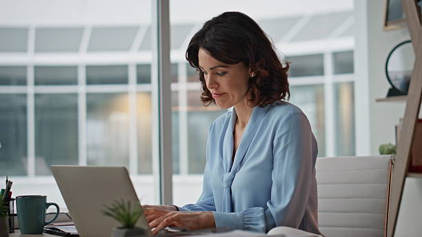 istock Busy entrepreneur checking papers after typing laptop in modern office closeup 2205937100