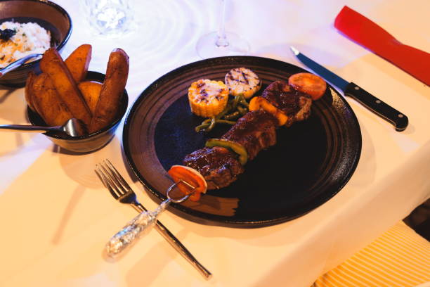 Indulge in these Delicious Grilled Skewers accompanied by Sides in an Elegant Setting