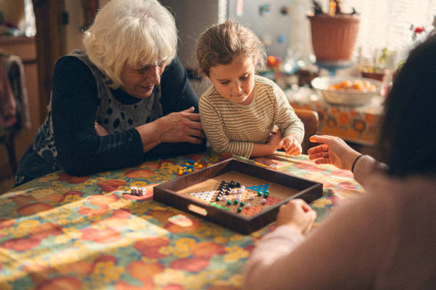 istock Family Connection. Multigenerational Family Plays Board Game 2205944986