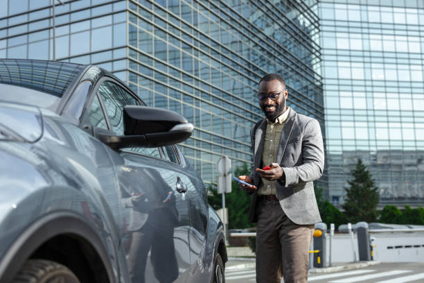 istock Professional man unlocking his car in a modern urban environment 2205946493
