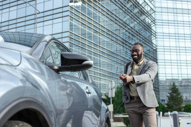 istock Professional man unlocking his car in a modern urban environment 2205946500