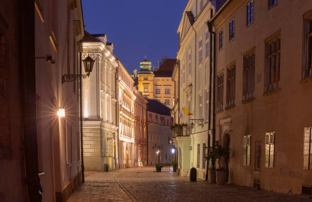Night view of a historic street in Krakow, Poland.
