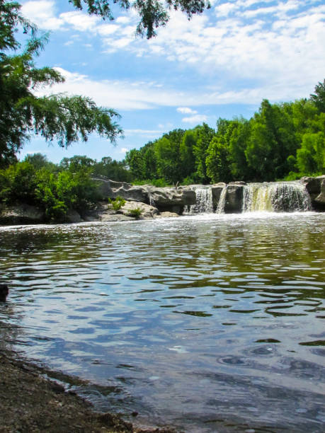 istock Waterfall Into With Large Gray Rock Into A Stream McKinney Falls 2205947917