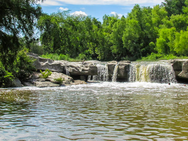 istock Waterfall Into With Large Gray Rock Into A Stream McKinney Falls 2205947920