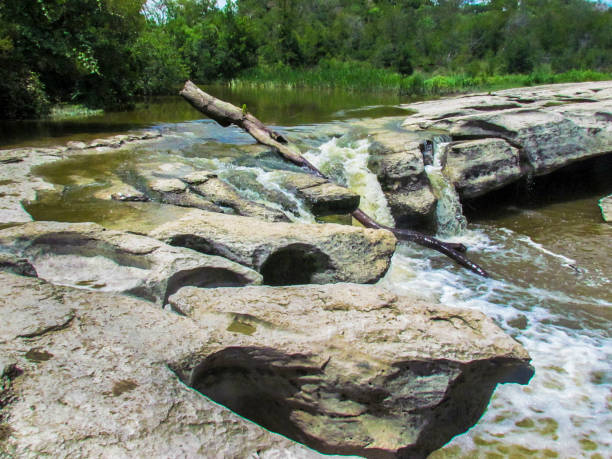 istock Rock Stream Of Water Fall With A Fallen Tree Trunk 2205947930