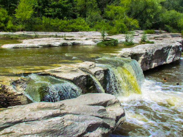 istock Waterfall Into With Large Gray Rock Into A Stream 2205947968