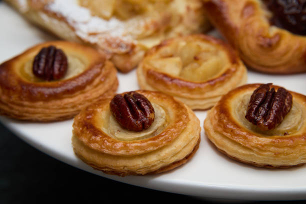 istock Assorted Miniature Danishes Topped with Nuts on a Plate 2205948543