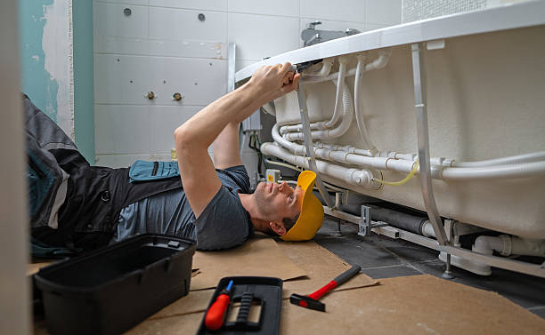 istock Man servicing the pipe system of a bathtub with hydromassage. 2205956794