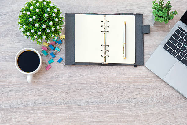 istock Top view desk with computer or laptop with a pen and a book and office equipment for work area copy space and work from home or education school background concepts. 2205958896