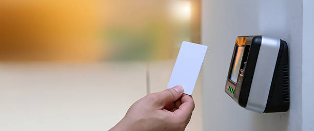 istock Proximity card reader door unlock, Close up hand of security man using ID card to scanning at the access control system for identity verification to open the door or check attendance. 2205958902
