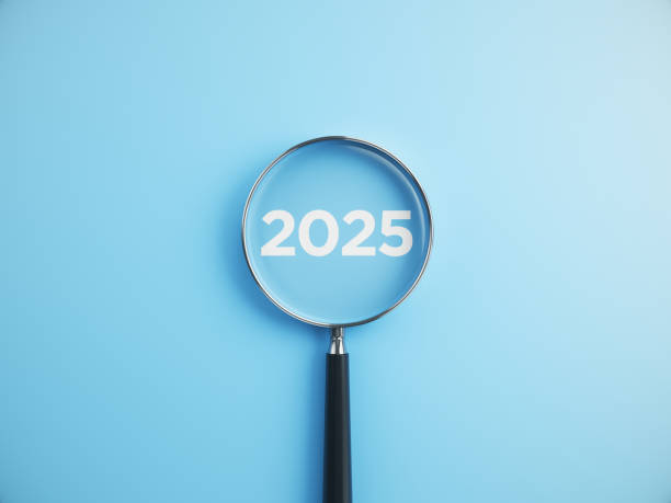 istock 2025 wording inside of Magnifying glass on an blue background 2205958998