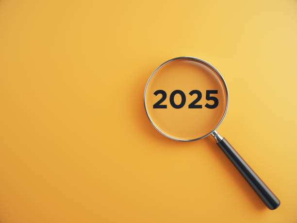 istock 2025 wording inside of Magnifying glass on an blue background 2205959022
