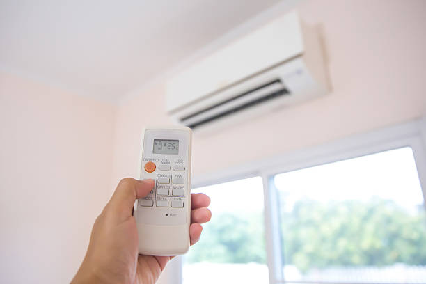 istock Close up remote set adjust temperature at 25 degrees of air conditioner split type wall mounted in home room concepts of cool or heat air cleaner and service repairing and maintenance. 2205959092