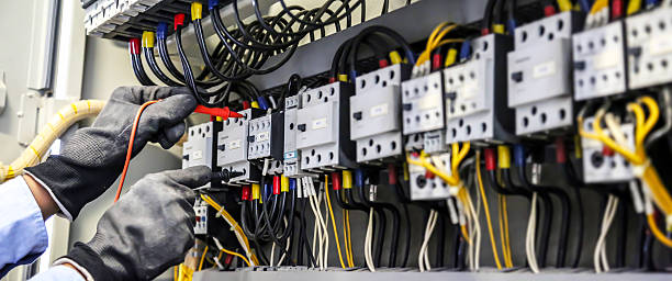 istock Close-up hand of electrical engineering using measuring equipment tool to checking electricity at circuit breaker and cable wiring system for maintenance main power distribution board. 2205959103