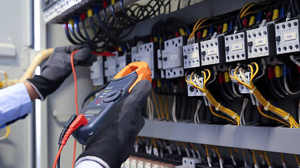 istock Close-up hand of electrical engineering using measuring equipment tool to checking electricity at circuit breaker and cable wiring system for maintenance main power distribution board. 2205959106