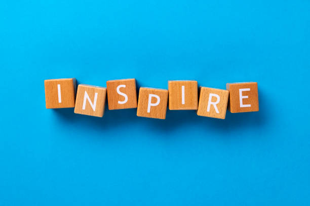 istock Block Words with Inspire on a Blue Background 2205959391