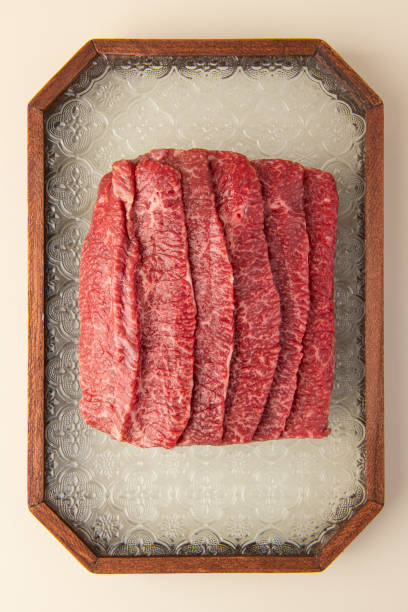 istock Sliced raw beef displayed in a wooden frame 2205962506