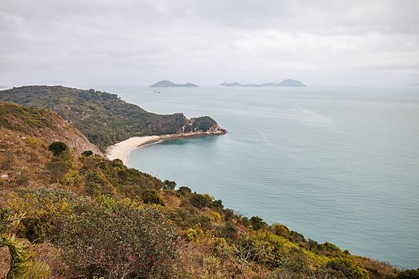 istock Serene Coastal Landscape with a Curved Beach in a Cloudy Day 2205965134
