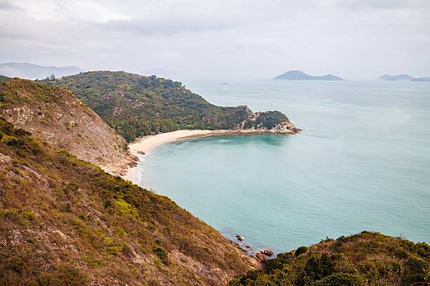 istock Serene Coastal Landscape with a Curved Beach in a Cloudy Day 2205965156