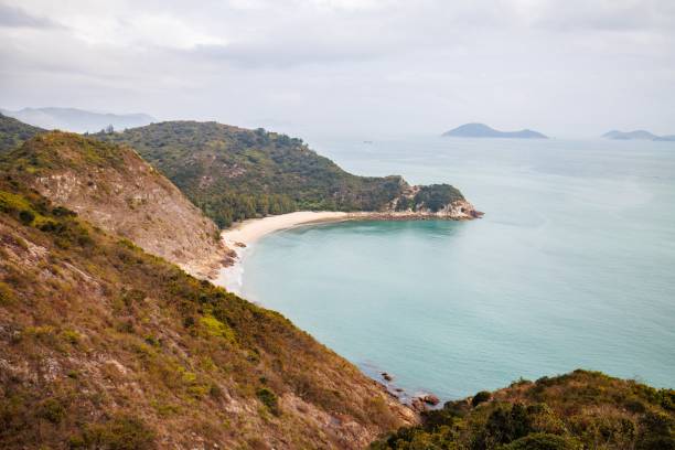 istock Serene Coastal Landscape with a Curved Beach in a Cloudy Day 2205965157