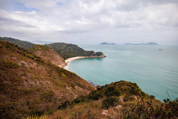 istock Serene Coastal Landscape with a Curved Beach in a Cloudy Day 2205965159