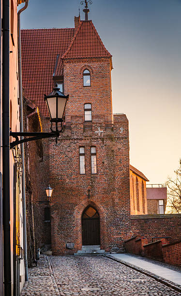 istock Charming brick tower at dusk, showcasing historic architecture and cobblestone streets in a quaint village 2205966836