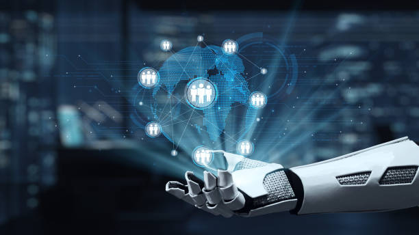 istock Futuristic robotic hand interacting with digital globe and holographic representations of people and connections in modern technology environment. Auvana 2205967536