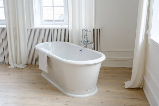 istock Bright and Elegant White Bathroom with Large Window 2205973289