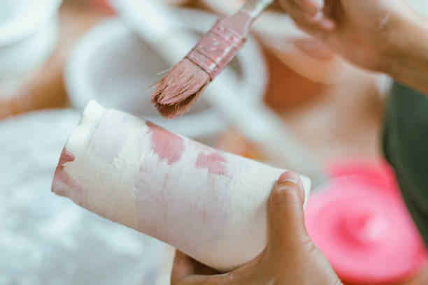 istock woman learning color painting her pottery 2205976965