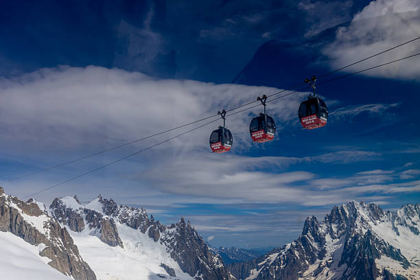 Cable car gondola in Chamonix Mont Blanc. Aiguille du Midi, Brevent and Valle Blanche Cable Car Telecabine Panoramic Mont-Blanc in French Alps mountain area. The top of the mountain glacier view point