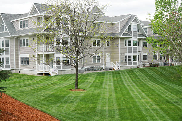 istock apartment building with mowed green front lawn 2205979246
