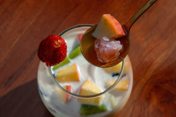 Es teler, Indonesian traditional cold dessert usually made from creamy sweetened milk, added with sliced fruits such as avocado, melon, strawberry, jackfruits, and served cold. Placed on wooden table