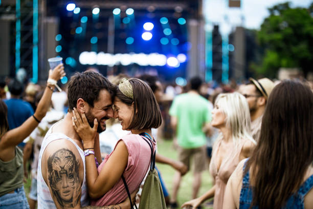 istock Embraced couple having fun on music concert. 2205982725
