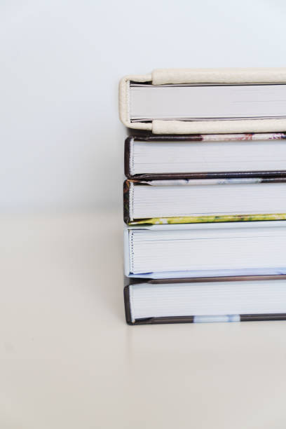 istock Folded photo books with white leather and multi-colored photo covers. 2205984808