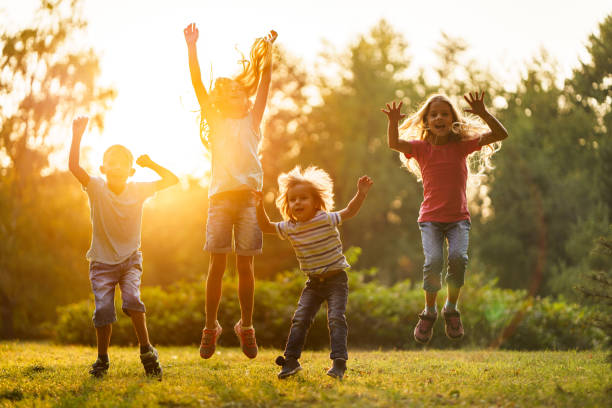 istock Children jumping in public park 2205991099