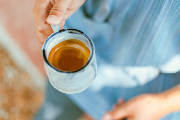 istock hand holding a cup of espresso shot. 2205993070