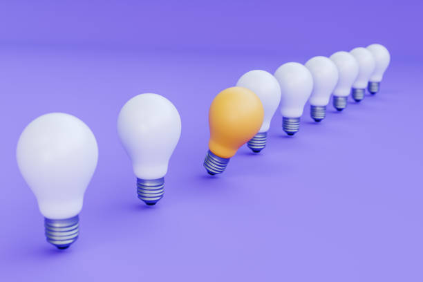 istock Unique Yellow Bulb in Line of White Bulbs 2205995768