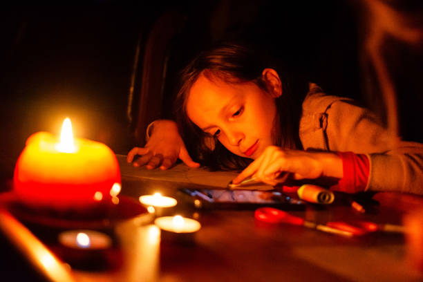 istock Girl draws during a power outage at home 2205995786