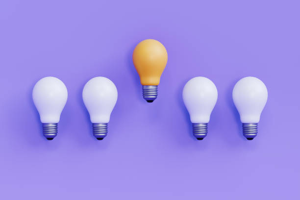 istock One Unique Yellow Bulb Among White Bulbs On Purple Background 2205995804