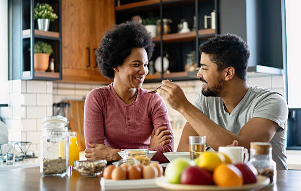 istock Happy couple having breakfast together in the kitchen 2205996206