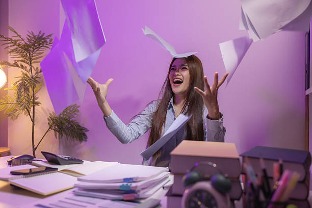 istock after working overtime for hours, this employee finally finished her work, she was very happy to finish it on time and go home to rest, overtime, tired, happy, businesswoman, deadline 2205996604