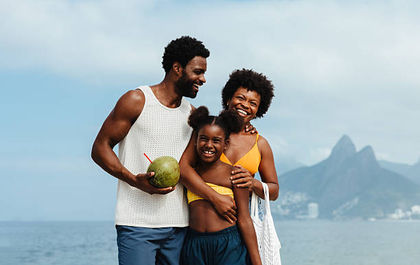 istock Joyful family embracing at Ipanema Beach during summertime 2205996782