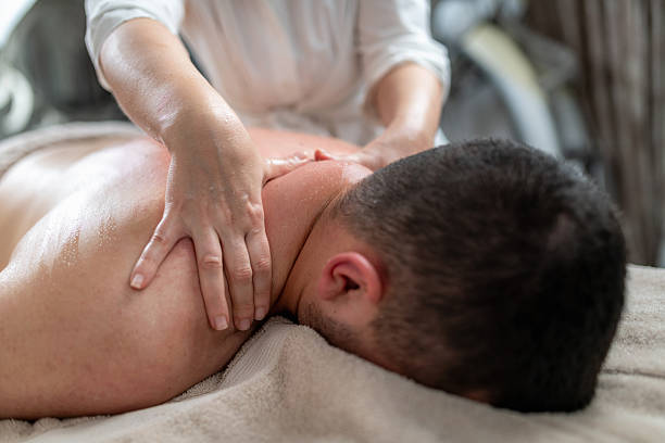 istock Therapist exfoliates the back using circular motions, focusing on dry patches. This technique removes dead skin cells, unclogs pores, and enhances skin texture for a smoother, healthier appearance. 2205998631