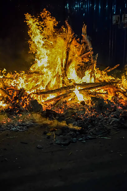 istock Fire flames on black background, Blaze fire flame texture background, Beautifully, the fire is burning, Fire flames with wood and cow dung bonfire 2205999599