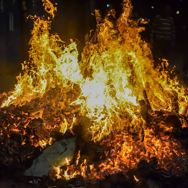 istock Fire flames on black background, Blaze fire flame texture background, Beautifully, the fire is burning, Fire flames with wood and cow dung bonfire 2205999603