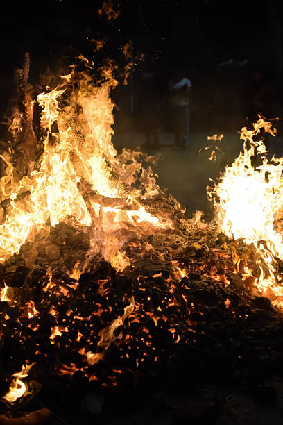 istock Fire flames on black background, Blaze fire flame texture background, Beautifully, the fire is burning, Fire flames with wood and cow dung bonfire 2205999607