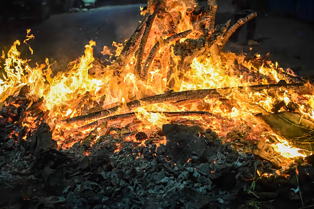istock Fire flames on black background, Blaze fire flame texture background, Beautifully, the fire is burning, Fire flames with wood and cow dung bonfire 2205999632