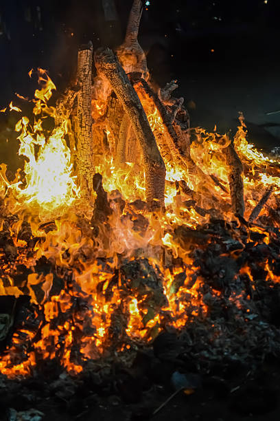 istock Fire flames on black background, Blaze fire flame texture background, Beautifully, the fire is burning, Fire flames with wood and cow dung bonfire 2205999653